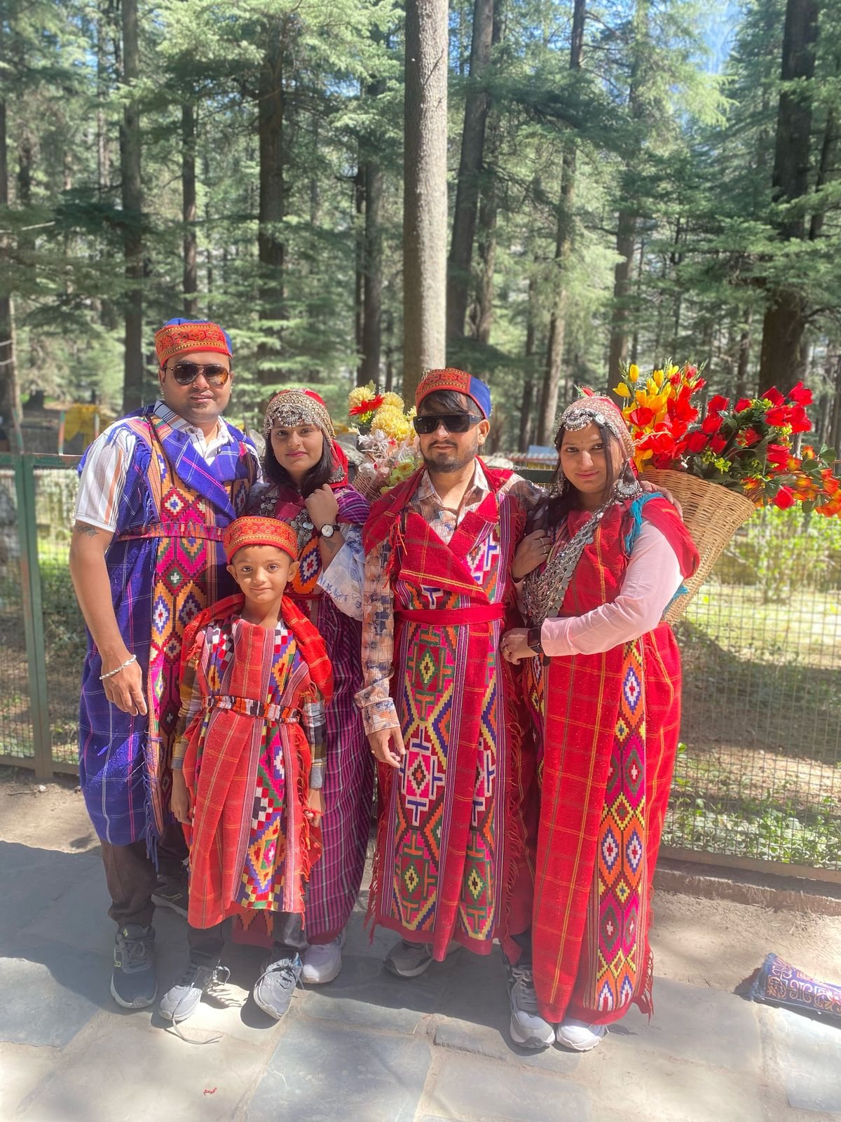 Family in traditional Himachali dress near Manali forest